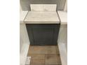 Close up of the kitchen grey cabinetry with light veined countertop and light wood flooring at 355 Chesapeake Cmns St # 112, Garner, NC 27529