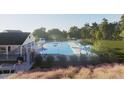 Community pool with lounge chairs, umbrellas, and expansive pool deck, perfect for summertime at 359 Chesapeake Cmns St # 113, Garner, NC 27529