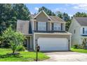 Charming two-story home with a two-car garage and well-maintained landscaping at 4009 Patriot Ridge Ct, Raleigh, NC 27610