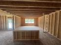 Unfinished living room displaying exposed wood framing and ample space with natural lighting at 433 Old Fashioned Way Way, Lillington, NC 27546