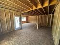 Unfinished living area featuring open framework and a rear entrance, providing plenty of potential at 433 Old Fashioned Way Way, Lillington, NC 27546