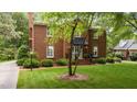 Charming brick two-story home featuring a well-manicured lawn and a welcoming front entrance with a black awning at 441 Fieldstone Dr, Burlington, NC 27215