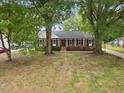 Charming brick home featuring a lush green lawn and mature trees at 5110 Old Well St, Durham, NC 27704