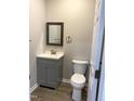 Bathroom with gray vanity, updated fixtures, and toilet at 701 Linwood Ave Ave, Durham, NC 27701