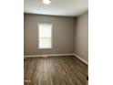 Neutral bedroom featuring gray walls and wood flooring at 701 Linwood Ave Ave, Durham, NC 27701