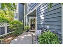 Charming front entrance with a wooden bench, potted plants, and stylish exterior at 7601 Wellesley N Park, Raleigh, NC 27615