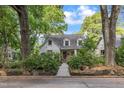 Inviting two-story home with a white facade and lush, mature trees at 821 Onslow St, Durham, NC 27705