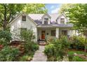 Beautiful home exterior with colorful flowers, a brick facade, and a welcoming front porch at 821 Onslow St, Durham, NC 27705