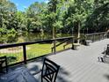 Overlooking the lake, this spacious deck is perfect for entertaining with areas for dining and relaxing at 8620 Glendale Dr, Apex, NC 27539