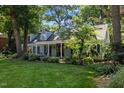 Beautiful single-Gathering home with lush landscaping, a covered front porch, and classic dormers, creating a welcoming curb appeal at 924 Pebblebrook Dr, Raleigh, NC 27609