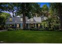 Charming single-Gathering home boasts a lush green lawn and mature trees, complete with a covered porch and traditional dormers at 924 Pebblebrook Dr, Raleigh, NC 27609