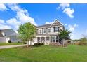 Beautiful two-story home with lush green lawn and inviting front porch, perfect for Gathering living at 104 Bollienger Dr, Princeton, NC 27569