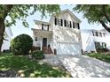 Charming two-story home with a two-car garage, well-maintained lawn and beautiful tree at 109 Troyer Pl, Apex, NC 27502