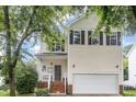 Charming two-story home with a well-maintained lawn and an attached two-car garage at 109 Troyer Pl, Apex, NC 27502