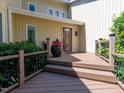 Relaxing front porch with wood decking, black metal railings, and decorative plants at 112 Lancaster Dr, Chapel Hill, NC 27517