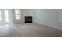 Bright living room featuring a cozy fireplace and natural light at 115 Abingdon Ct # 2B, Cary, NC 27513