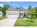 Attractive single-Gathering home with a well-kept lawn, attached garage, and a welcoming front entrance at 115 Jensen Dr, Wendell, NC 27591