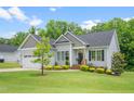 Well-maintained single-Gathering home with a lush green lawn and charming curb appeal on a sunny day at 115 Jensen Dr, Wendell, NC 27591