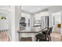 Bright kitchen with granite countertops, breakfast bar seating, stainless steel appliances, and white cabinets at 115 Jensen Dr, Wendell, NC 27591