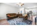 Inviting living room with plush sofas, a patterned rug, and plenty of natural light from the open floor plan at 115 Jensen Dr, Wendell, NC 27591