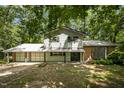 Two-story home with attached garage, and a yard surrounded by mature trees at 134 Chateau Rd, Durham, NC 27704