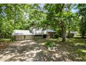 Two-story home with attached garage, and a yard surrounded by mature trees at 134 Chateau Rd, Durham, NC 27704