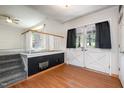 Bright living room with staircase, white french doors, and wood laminate flooring at 134 Chateau Rd, Durham, NC 27704