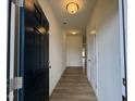 Inviting hallway with wood-look flooring and neutral paint leads to the main living areas at 136 Bruce Dr Dr, Dunn, NC 28334