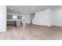 Open-concept layout with hardwood floors, seamlessly connecting the living area and kitchen, ideal for modern living at 136 Bruce Dr Dr, Dunn, NC 28334