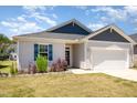 Charming single-story home with a two-car garage, and well-manicured lawn at 157 Willow Grove Ln, Fuquay Varina, NC 27526