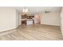 Open-concept living space with wood-look floors adjacent to the kitchen at 157 Willow Grove Ln, Fuquay Varina, NC 27526