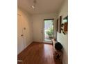 Bright foyer with hardwood floors, bench, and coat closet offers a welcoming entrance at 1708 Quail Ridge Rd, Raleigh, NC 27609