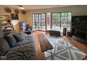 Comfortable living room featuring a large sofa, and windows with backyard views at 1708 Quail Ridge Rd, Raleigh, NC 27609