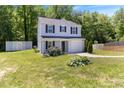 Inviting two-story home featuring a one car garage, lush landscaping, and well-maintained front lawn at 194 Catskill Ct, Burlington, NC 27217