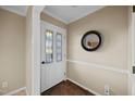 Bright foyer with a decorative glass front door, wood floor, and neutral colored walls at 1973 Elon Ossipee Rd, Elon, NC 27244