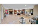 Open concept living room with a stone fireplace, kitchen island, and dining room chandelier at 1973 Elon Ossipee Rd, Elon, NC 27244