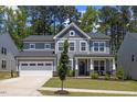 Beautiful two-story home featuring a well-manicured lawn and an attached two-car garage at 2009 Latham Oaks Ave, Wake Forest, NC 27587