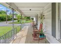 Spacious front porch with ample seating and charming decor, offering a welcoming outdoor living space at 219 W Parker St, Graham, NC 27253
