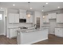 Modern kitchen showcasing white cabinets, granite countertops, stainless steel appliances and pendant lighting at 224 Wild Turkey Way, Lillington, NC 27546