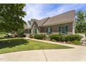 Beautiful brick home featuring green shutters and a well-maintained lawn with a sidewalk at 229 Hocutt Farm Dr Dr, Clayton, NC 27527
