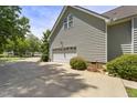Spacious two-car garage with a long driveway and well-maintained landscaping at 229 Hocutt Farm Dr Dr, Clayton, NC 27527