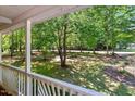 Overlooking view of the yard, captured from the covered porch with classic white railings at 25 Misty Way, Franklinton, NC 27525