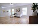 Bright living room with stylish decor, wood floors and large windows at 3021 Remington Oaks Cir, Cary, NC 27519