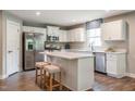 Bright kitchen with stainless steel appliances, an island with seating, and white cabinetry at 33 Elmwood Ave, Sanford, NC 27330