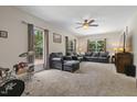 Comfortable living room with large windows for natural light and carpeted flooring offers a relaxing atmosphere at 3841 Rawls Church Rd, Fuquay Varina, NC 27526