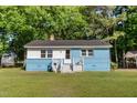 Cozy single-Gathering home showcasing painted blue brick and a well-maintained lawn at 403 N Webb St, Selma, NC 27576