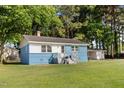 Charming one-story home with blue painted brick and a large, green lawn at 403 N Webb St, Selma, NC 27576