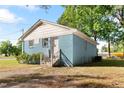 Rear view of a one story home featuring painted blue brick exterior and white trim at 403 N Webb St, Selma, NC 27576