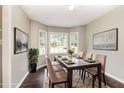 Bright dining room featuring a bay window for ample natural light and modern table setting at 5008 Dantonville Ct, Knightdale, NC 27545