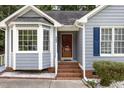 Close-up of a well-kept home featuring a bright red front door, complementing the exterior at 5008 Dantonville Ct, Knightdale, NC 27545